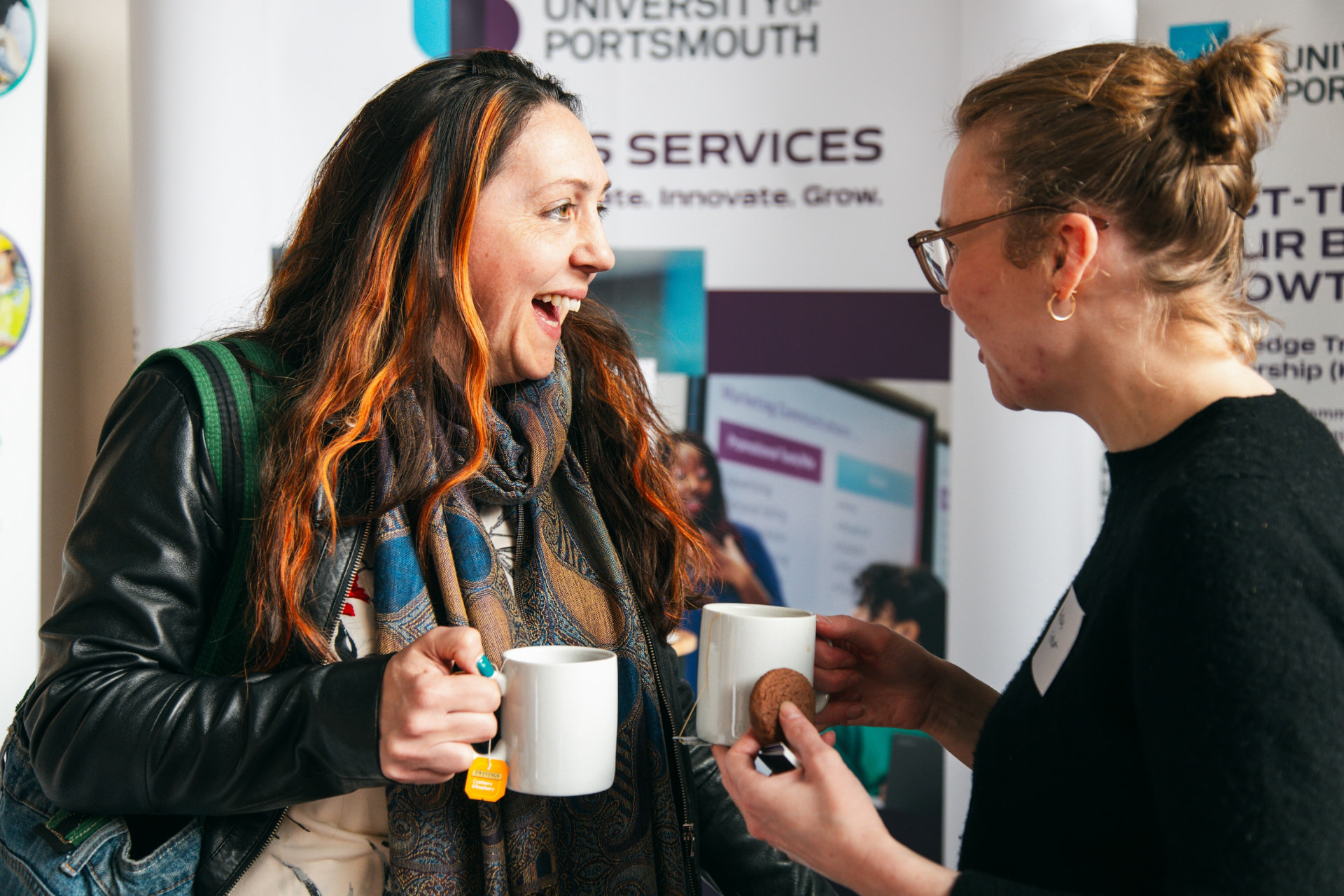 Two members in conversation over coffee at a Startup Disruptors gathering